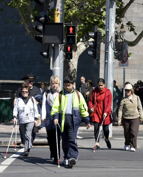 White cane users crossing at the Art Gallery on a sunny day