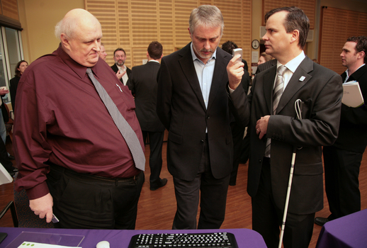 Jim Pipczak and Gavin Jennings listening to Chris Edwards text to speech device