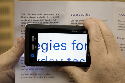 Screen magnifier in action with a brochure