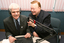 Bert Newton pushes microphone towards Stephen Jolley in the studio