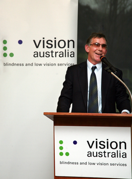 Dr Kevin Murfitt speaking at the podium