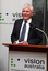 David Blyth speaking at the podium