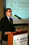 Dr Kevin Murfitt speaking at the podium