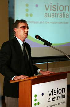 Dr Kevin Murfitt speaking at the podium