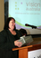 Maryanne Diamond speaking at the podium with her gift