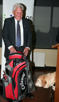 David Blyth with his golf clubs beside him