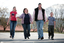 Tony Clarke with his wife, son and daughter walking in a schoolyard