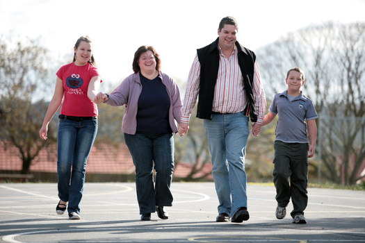 Tony Clarke with his wife, son and daughter walking in a schoolyard