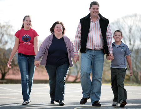 Tony Clarke with his wife, son and daughter walking in a schoolyard
