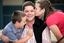 Tony Clarke getting a kiss from his son and daughter in a school yard