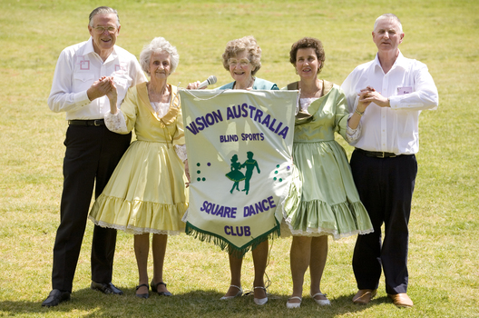 Margaret Fox and VA Square Dance club members with their banner