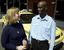 Taxi driver assisting a woman with a white cane 