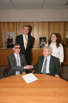 Dr Kevin Murfitt shaking hands with BCA person whilst Gerard Menses and Nadia Mattiazzo look on