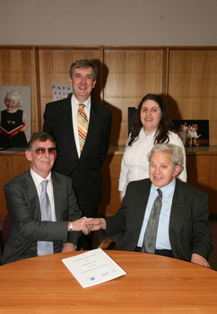 Dr Kevin Murfitt shaking hands with BCA person whilst Gerard Menses and Nadia Mattiazzo look on