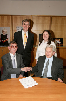 Dr Kevin Murfitt shaking hands with BCA person whilst Gerard Menses and Nadia Mattiazzo look on