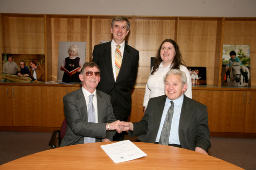 Dr Kevin Murfitt shaking hands with BCA person whilst Gerard Menses and Nadia Mattiazzo look on