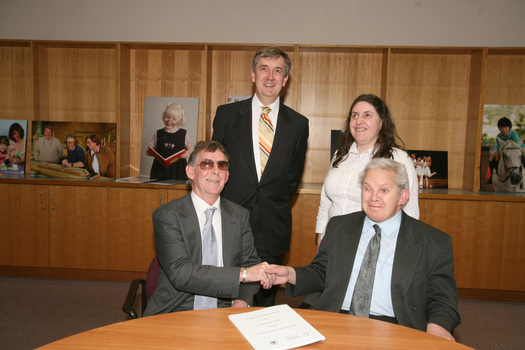 Dr Kevin Murfitt shaking hands with BCA person whilst Gerard Menses and Nadia Mattiazzo look on