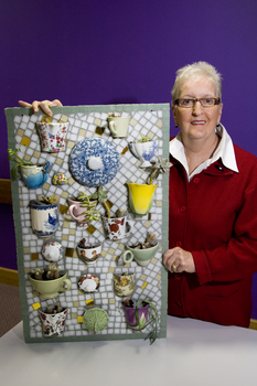 Woman with a mosaic of teacups