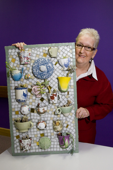 Woman with a mosaic of teacups