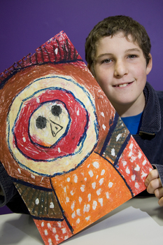 Boy with drawing of face and torso