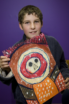 Boy with drawing of face and torso