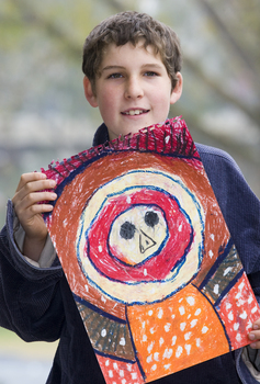 Boy with drawing of face and torso