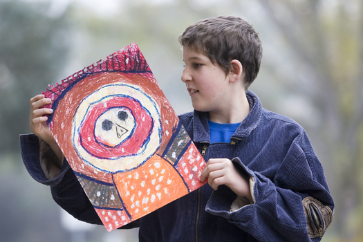 Boy with drawing of face and torso