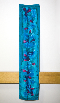 Blue dyed material with darker blue and pink against interior wall