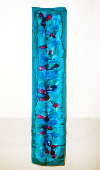 Blue dyed material with darker blue and pink against interior wall, with wood panelling removed