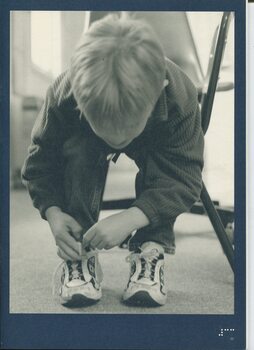 Image of child tying his shoelaces