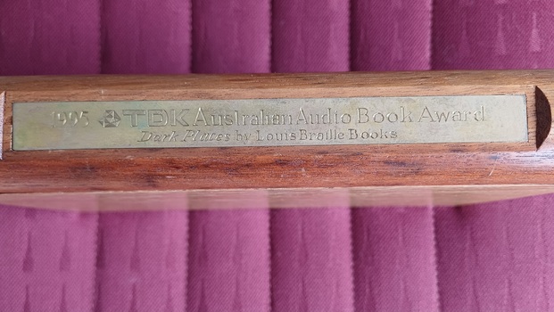Metal plate with inscription on side of wooden box