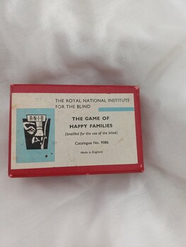 Red box with RNIB label 'The game of happy families'