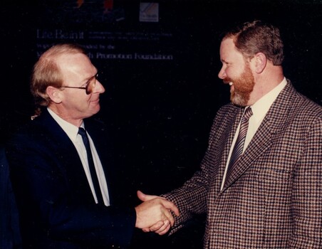 John Blackman shaking hands with Trevor Hay