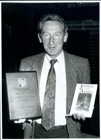Narrator James Wright with plaque and book