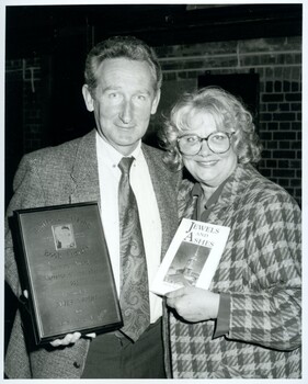 James Condon with unidentified female holding plaque and book