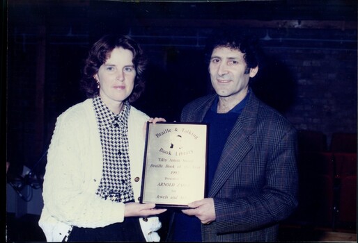 Unidentified female with author Arnold Zable and plaque