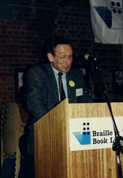 James Wright reads an excerpt from the podium