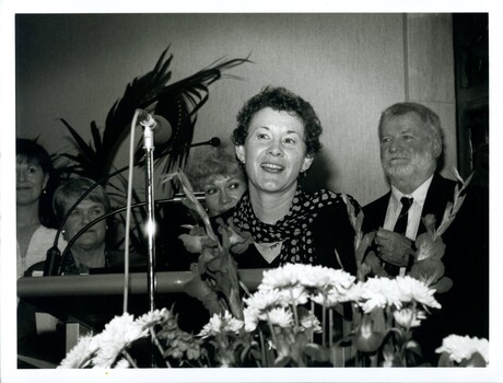 Rose Blustein at the podium with Beverley Dunn and Blanche d'Alpuget behind her