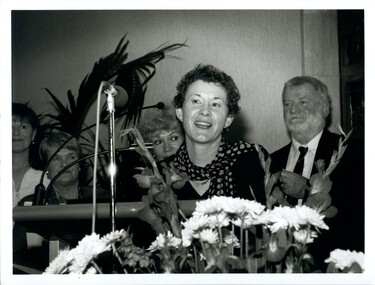 Rose Blustein at the podium with Beverley Dunn and Blanche d'Alpuget behind her