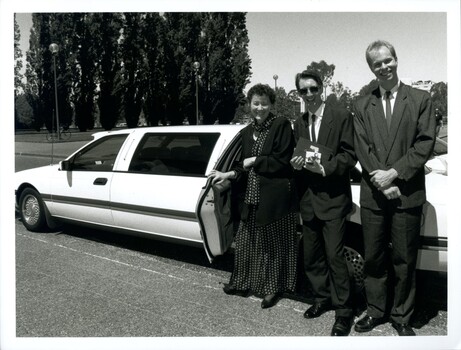Rose Blustein, Karl Hughes and Robert de Graauw standing beside the open door of a limousine