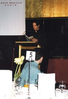 Narrator Stephen Pearse at the podium with Glen Morrow in the foreground