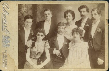 Five men and three women pose in evening clothes