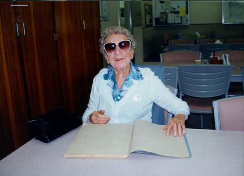 Elderly woman reading a Braille book