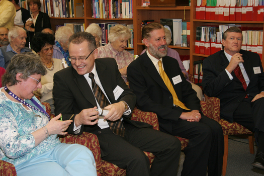 Audience in browsing library pull crackers including Tony Shepherd