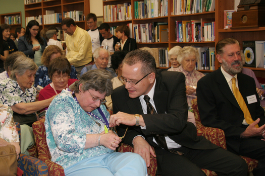 Audience in browsing library pull crackers including Tony Shepherd