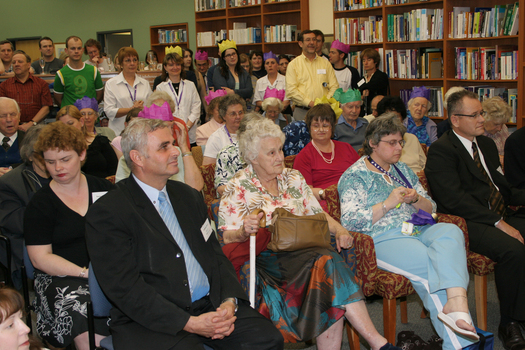 Audience members in the browsing library listening to speeches, Karen Knight and Lynne Kells far left