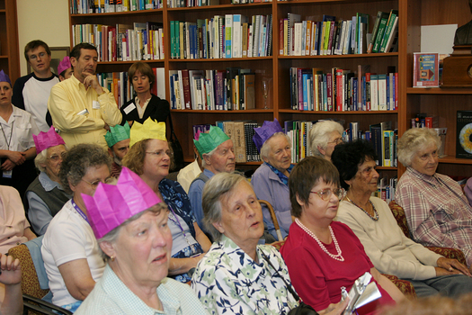 Audience members in the browsing library listening to Marina Prior