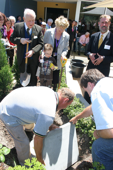 Reuben Ryan, Jarryd Clifford and Jennifer Gibbons watch the gardener caulk the covering plate with Peter North and Graeme Innes