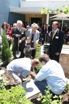 Reuben Ryan, Jarryd Clifford and Jennifer Gibbons watch the gardener caulk the covering plate with Peter North and Graeme Innes