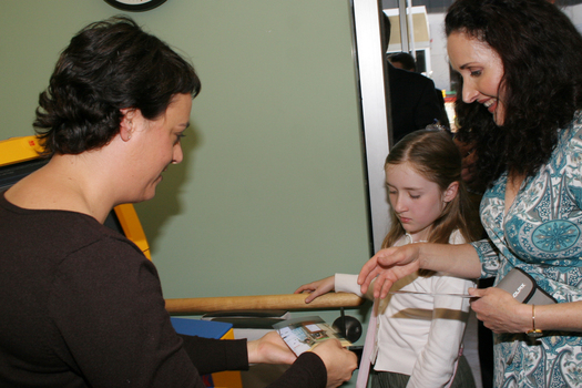 Marina Prior with her daughter getting photographs from the kiosk